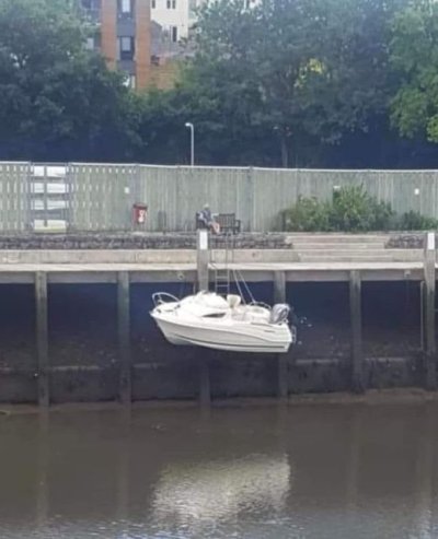 boat hung up by lines low tide.jpg