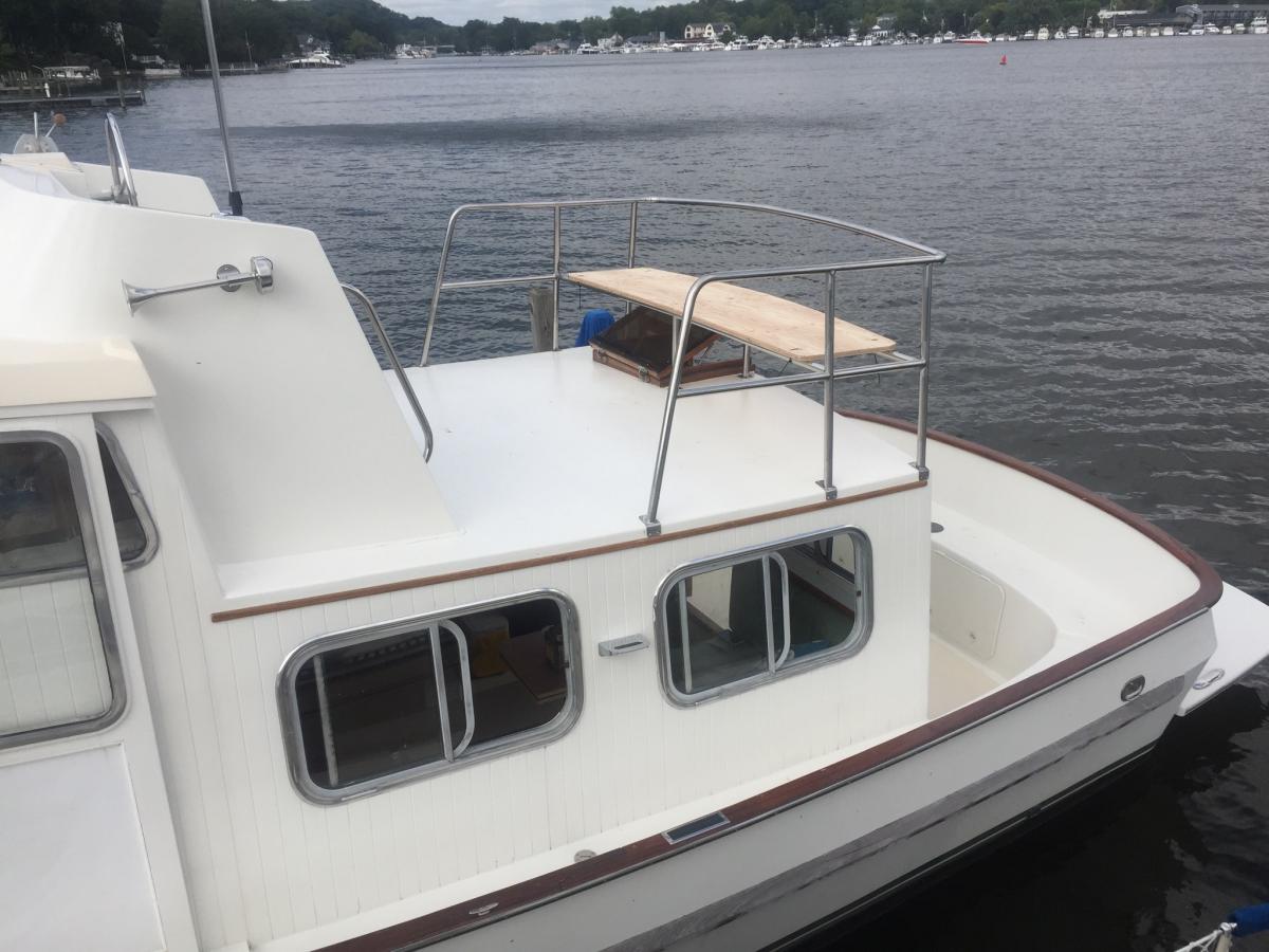 Pilot house new railing (bench seating in progress). We moved the aft ladder to make more room in the aft deck and added steps on port and starboard s