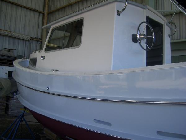 Port side of vessel.  Wheelhouse was repainted with Awlgrip.  Note new stainless steel rubrails.