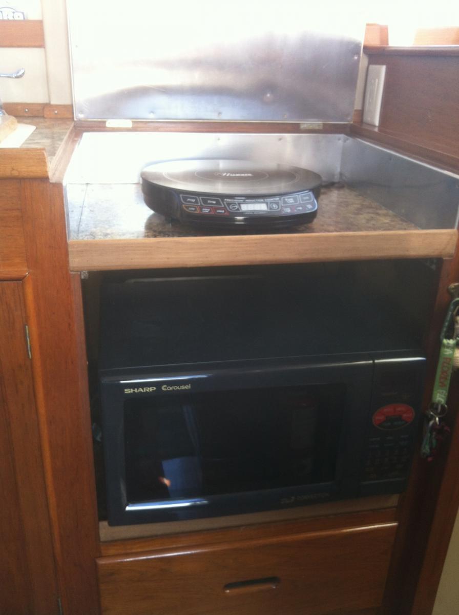 Propane stove/cooktop removed

Installed:
Combination microwave & convection oven.
Induction cooktop - no burned hands, works great!