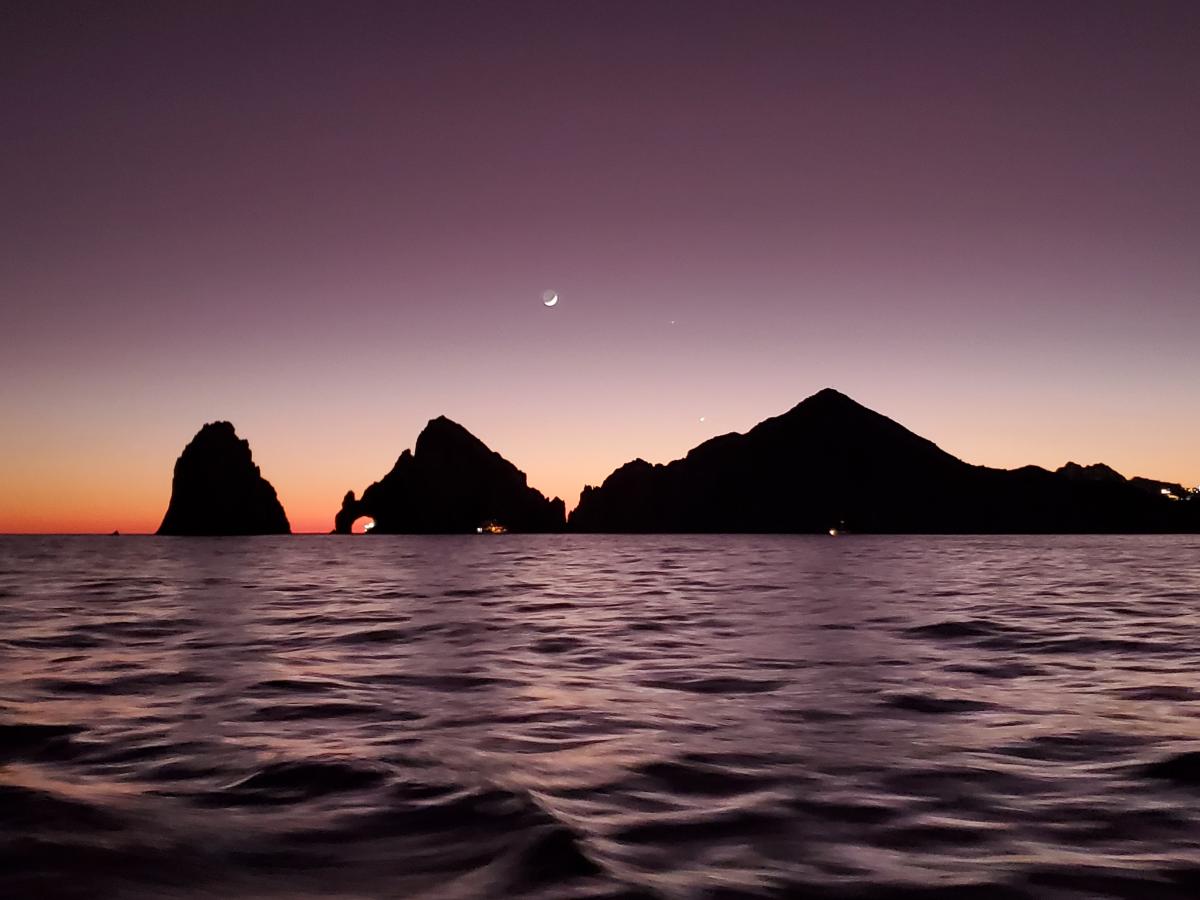 Sunset with crescent moon at Cabo San Lucas.