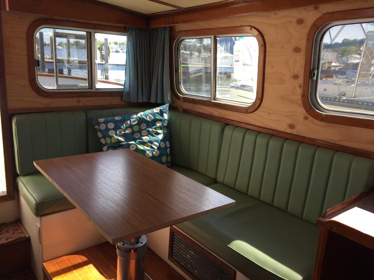 The boat had tons of interior water damage. Photo before installing Chilewich wallcovering. Also shown is temporary tabletop on adjustable base.